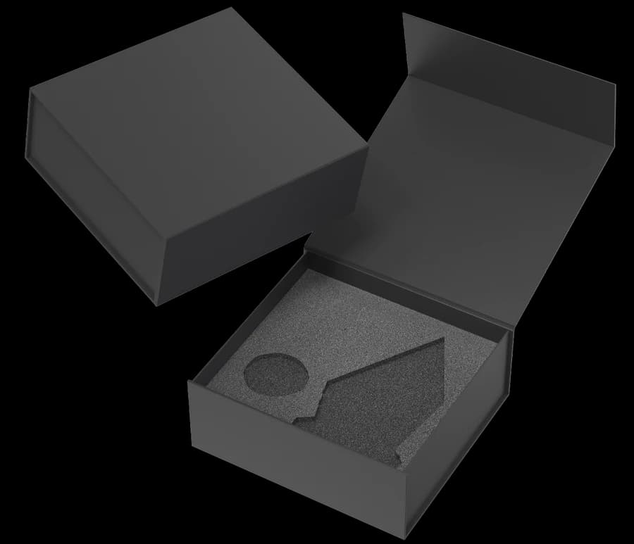 Black rigid gift box, open, with a custom-cut foam insert and an embossed lid